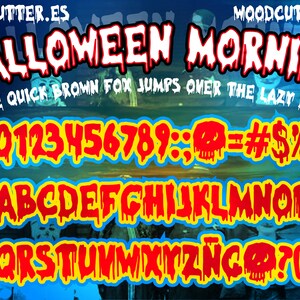 Peut inclure: Police de caract&egrave;res num&eacute;rique sur le th&egrave;me d'Halloween. Les mots "HALLOWEEN MORNING" sont dans une police rouge d&eacute;goulinante avec un contour blanc. Comprend des chiffres, des lettres et des symboles dans un style similaire.
