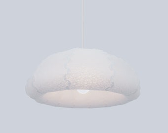 May include: White pendant light fixture with a textured, cloud-shaped shade.