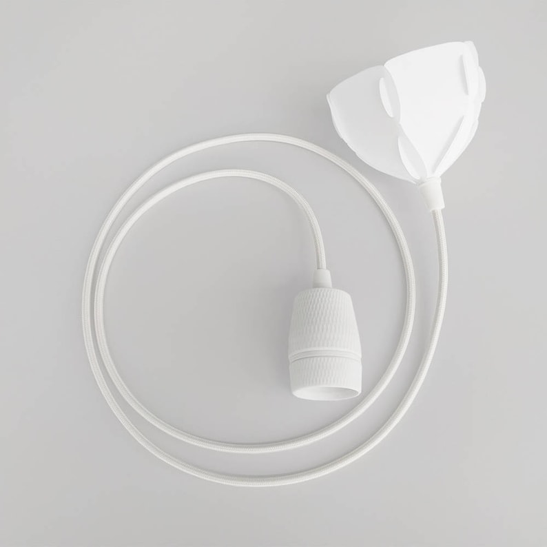 May include: White pendant light fixture with a white cord and a white ceramic socket. The shade is a white, folded paper design.