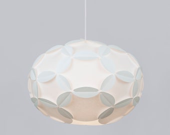 May include: A white pendant light with a round, geometric design. The light is made of overlapping circles that create a flower-like pattern.