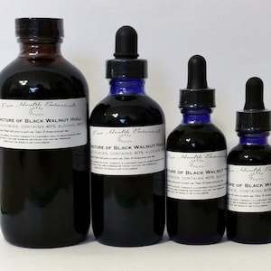 Peut inclure: Quatre flacons en verre de différentes tailles remplis d'un liquide foncé, probablement une teinture. Chaque flacon a un bouchon compte-gouttes noir et une étiquette blanche avec du texte. Les étiquettes indiquent "Teinture de coque de noix noire" et "Pure Health Botanicals."