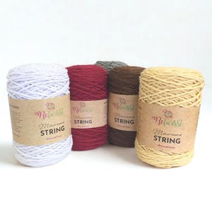 May include: Five cylindrical spools of Retwisst Macrame String in white, burgundy, dark grey, dark brown, and light yellow. Each spool features a brown paper label with the brand logo, the text Macrame String, and a social media handle.