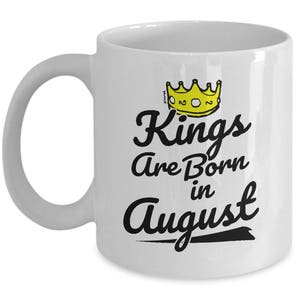 May include: White ceramic coffee mug with a black graphic that says "Kings Are Born in August" with a yellow crown above the text.