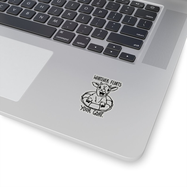 May include: A black and white sticker with a goat wearing a life preserver and the text "Whatever floats your goat."