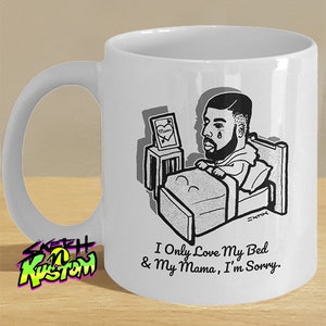 May include: White ceramic mug featuring a black and white illustration of a person in bed with the text "I Only Love My Bed & My Mama, I'm Sorry." The mug also has the text "@sketchnkustom" and a logo.