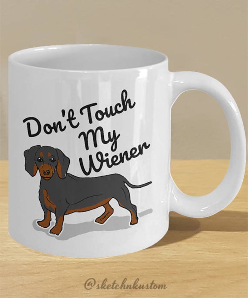 May include: White ceramic coffee mug with a black dachshund illustration and the text "Don't Touch My Wiener".