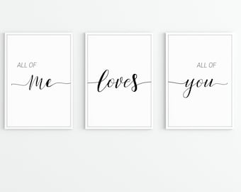 May include: Three white framed prints with black calligraphy. The first print says "All of me". The second print says "loves". The third print says "All of you".
