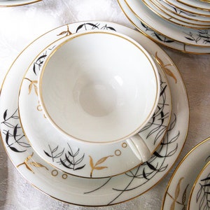 Schirnding Bavaria mid-century white, gold and black cups, flat saucers, plates and bowls; 1949 -1956. Absolutely gorgeous.