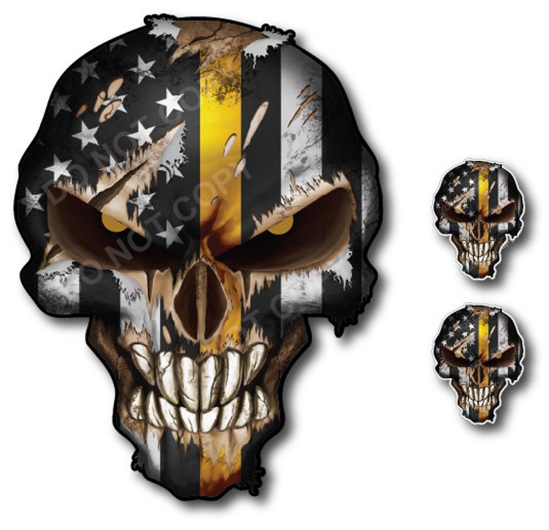 May include: A skull graphic featuring an American flag and a yellow stripe, representing the Thin Yellow Line, a symbol of support for law enforcement. The skull has a distressed and grunge aesthetic. Two smaller versions of the skull graphic are also included.