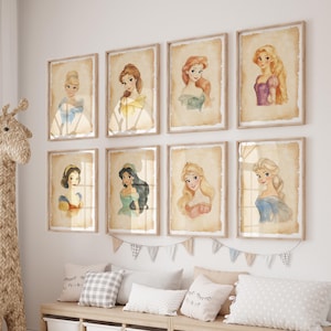 May include: A set of eight framed prints featuring Disney princesses. Each print has a watercolor illustration of a princess on a vintage-style background. The prints are arranged in two rows of four on a white wall.