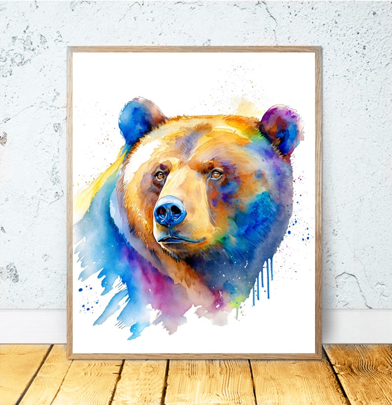 Puede incluir: Pintura de acuarela de la cabeza de un oso marr&oacute;n con acentos azules, morados y amarillos. El oso mira hacia la derecha y el fondo es blanco con salpicaduras de pintura.
