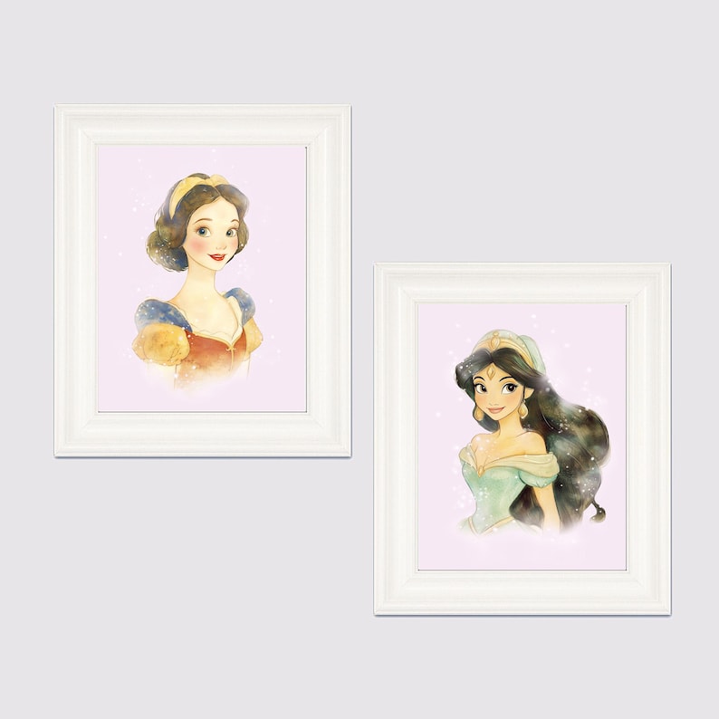 May include: Two framed watercolor prints featuring portraits of animated princesses. One print shows a princess with dark hair and a yellow headband, wearing a red and blue dress. The other print depicts a princess with long black hair and a green dress.
