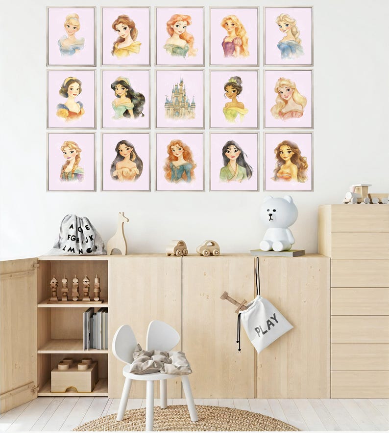 May include: A collection of framed watercolor portraits of various princesses, displayed on a white wall. The portraits feature the princesses with different hairstyles and gowns. The room also includes a wooden cabinet, a white chair, and decorative items.