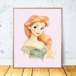 May include: A framed watercolor print of a princess with long, flowing red hair and a green off-the-shoulder dress. The artwork has a soft, dreamy quality, with a light pink background and subtle sparkle effects. The frame is a light brown color.