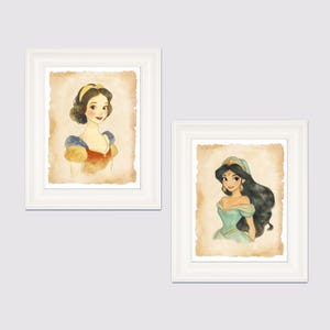 May include: Two framed watercolor illustrations of Disney princesses. The first illustration features Snow White with a red and yellow dress and a yellow headband. The second illustration features Jasmine with a blue dress and a gold headband.