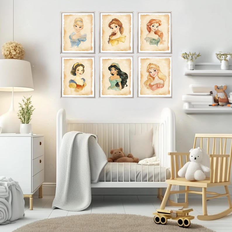 May include: A set of six framed prints featuring Disney princesses. Each print has a watercolor illustration of a princess with a light background. The prints are arranged in two rows of three on a white wall.