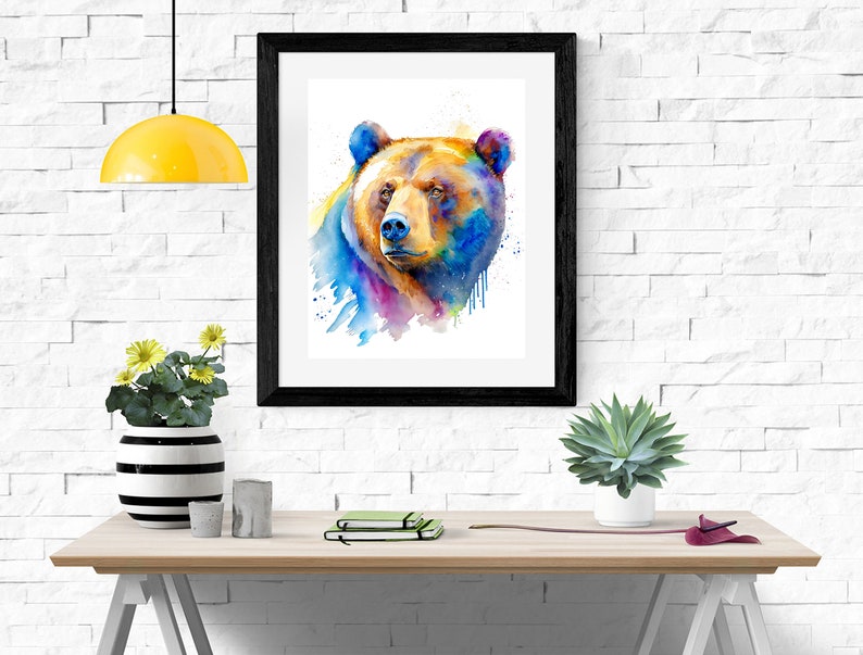 Puede incluir: Una pintura de acuarela de la cabeza de un oso marr&oacute;n con salpicaduras de pintura azul, p&uacute;rpura, amarilla y naranja.