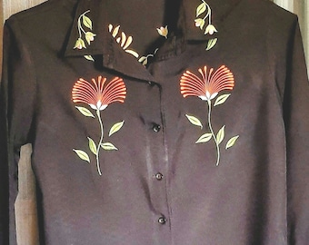 Beautiful silky black long sleeved blouse embroidery embellished with flowers and greenery on cuffs and neck as well. excellent condition S