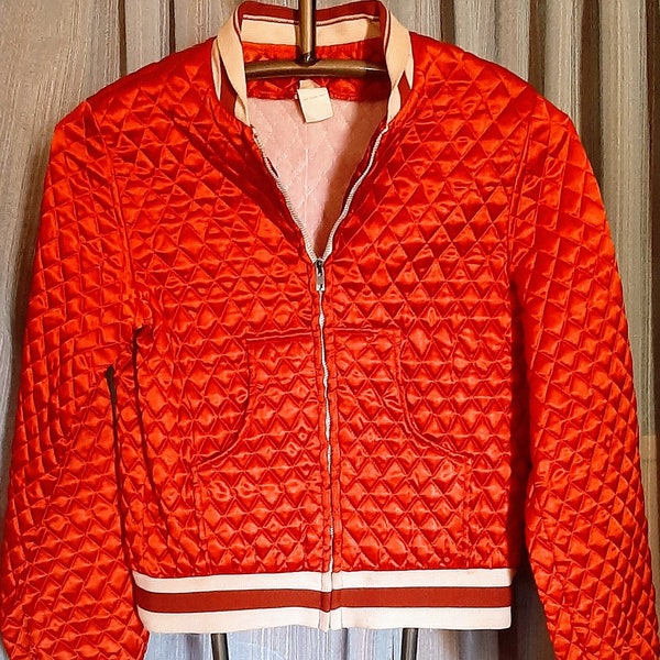 Vintage red quilted,  zip up front, two pocket sports type jacket in excellent condition,  size is a junior med