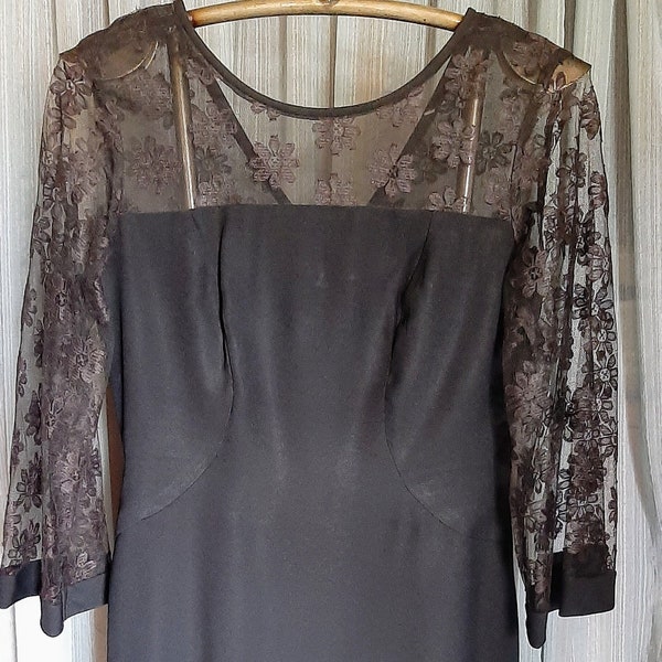 Vintage black fitted dress with lace yoke and bell sleeves in excellent condition,size 12