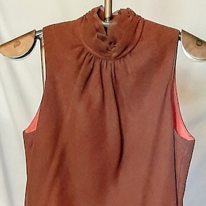 Vintage sleeveless floor length sheer brown pleated fabric over a coral liner in excellent condition,  size 10