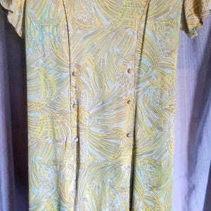 70s classic blue dress with geometric Green, two front pleats and buttons.  Fabric classic 70s.  dress in very good condition.  size 14.