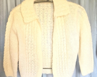 Beautiful ivory colored hand kni 1960s mohair sweater jacket, button closure in excellent condition.   Armpit to armpit is 22".  Length 21"