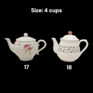 May include: Two white ceramic teapots with floral designs. One teapot has a textured pattern and pink flowers, the other has a floral border. The text "Size: 4 cups" is at the top.