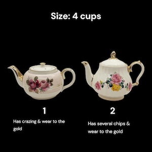 May include: Two vintage teapots with floral designs. One is pink with red roses, the other is white with pink and yellow roses. Both have gold accents and are labeled "Size: 4 cups". The first has crazing and wear to the gold, the second has chips and wear.