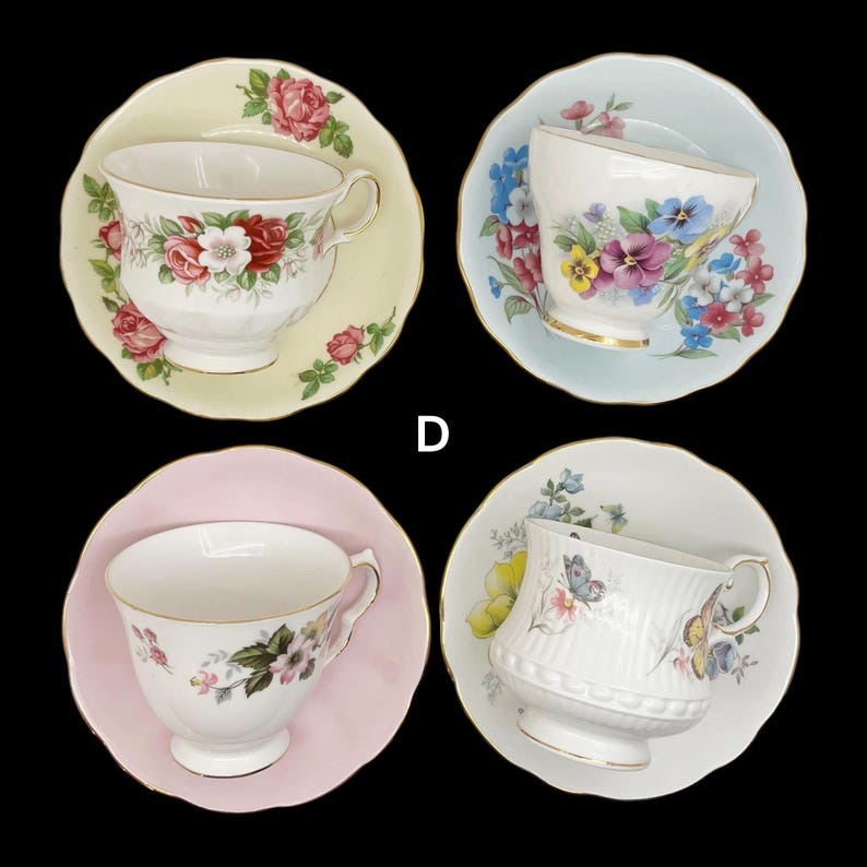 May include: Four vintage teacups and saucers are displayed against a black background. Each teacup features a different floral design, with colors including pink, red, blue, and yellow. The saucers are in matching colors.