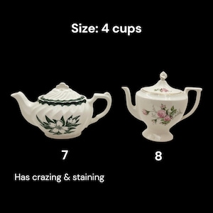 May include: Two white teapots with lids. One teapot has a green floral design and the other has pink roses. The text "Size: 4 cups" is above the teapots. The text "Has crazing & staining" is below the first teapot.