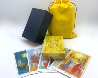 May include: A deck of tarot cards with a yellow and gold design. The cards are in a blue box with the words "Light Workers" on the front. The cards are also in a yellow velvet bag with a white symbol on the front.