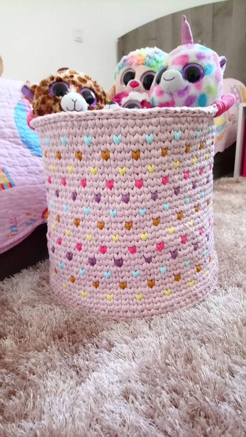 Large basket of multicolored crochet toy storage for baby or little girl