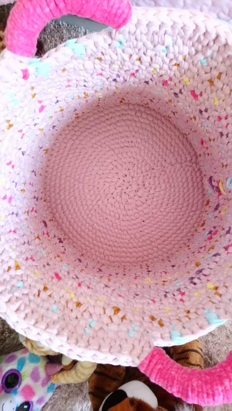Large basket of multicolored crochet toy storage for baby or little girl