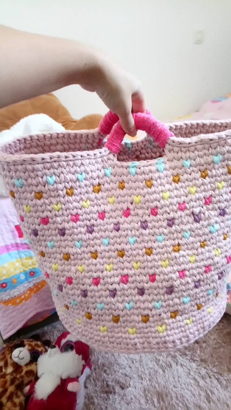 Large basket of multicolored crochet toy storage for baby or little girl