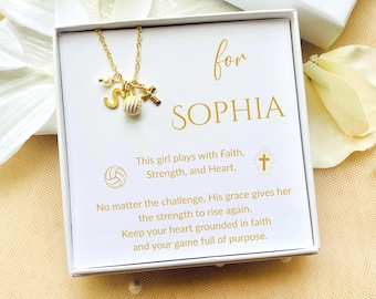 May include: A gold-colored necklace with a volleyball charm, a letter "S", a cross, and a pearl, presented in a white gift box. The box has the name "SOPHIA" and inspirational text.