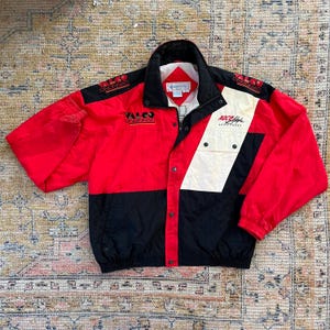May include: A red, white, and black windbreaker jacket with the text "YALCO ORIGINAL" and "RACE-A-HYFE SPORTSWEAR" on the front.