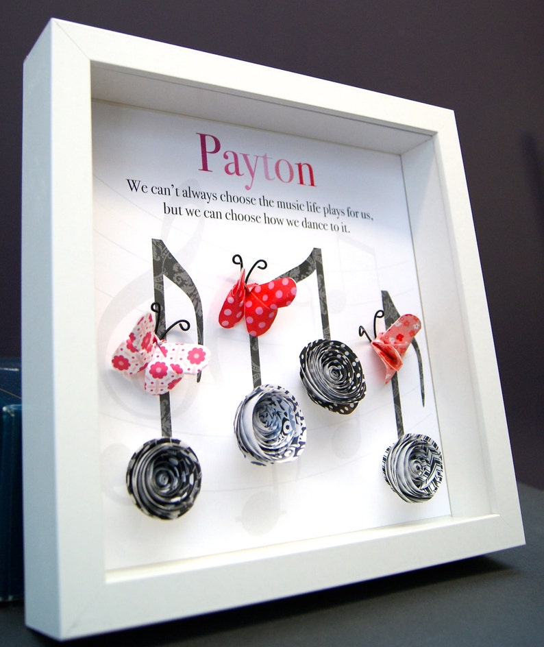 May include: A white framed picture with the name "Payton" at the top. The quote "We can't always choose the music life plays for us, but we can choose how we dance to it." is printed below the name. The picture features five paper butterflies and five paper flowers in black and white.