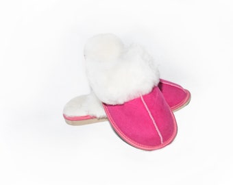 May include: A pair of pink sheepskin slippers with white fur lining. The slippers are soft and cosy, perfect for keeping your feet warm in the winter.