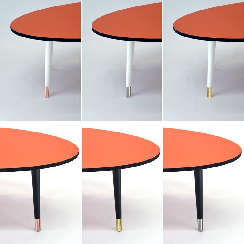 Oval Coffee Table With Black Edge, Tapered Legs and Stainless Steel