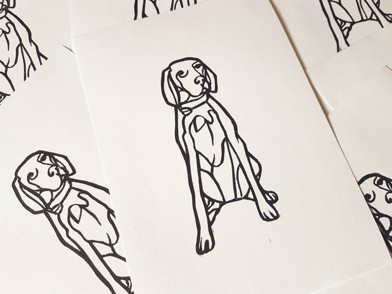 May include: A collection of white cards featuring a black line drawing of a dog in a seated position. The dog has a collar and is depicted with simple, bold lines. The cards are arranged in a slightly overlapping pattern.