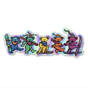 May include: Holographic sticker featuring five dancing bears in various colors, each with skis or a snowboard. The bears are wearing hats and have lightning bolt designs. The sticker has a shiny, iridescent finish.