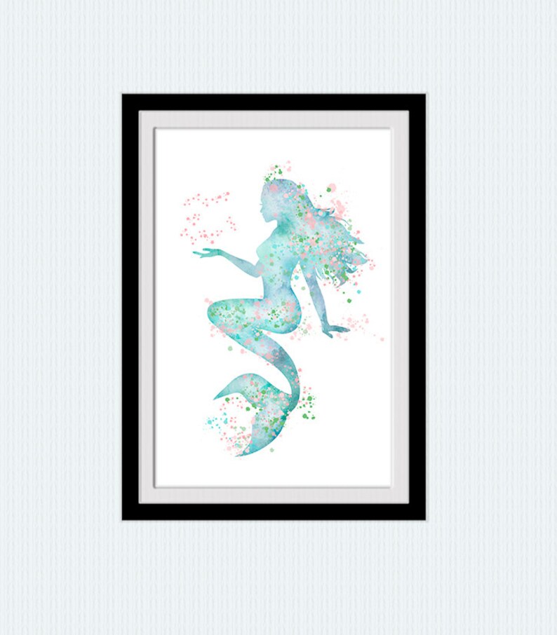 May include: A watercolor painting of a mermaid with a blue tail and pink and green accents. The mermaid is sitting with her tail curled around her and her hand outstretched.