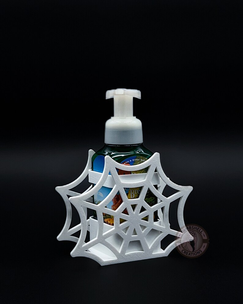 May include: White 3D printed spiderweb soap dispenser holder. The holder is designed to fit a standard size foaming soap bottle. The holder is a great way to add a spooky touch to your bathroom decor.