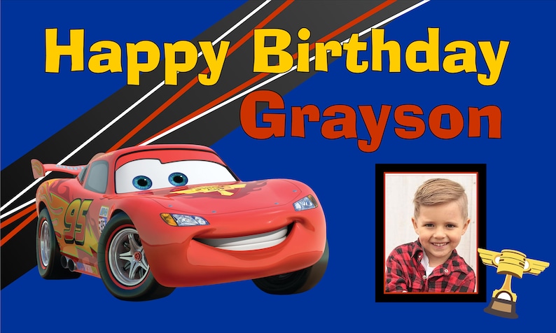 May include: A red race car with a number 95 on the side, a smiling face, and blue eyes. The car is on a blue background with black and red stripes. The text "Happy Birthday Grayson" is in yellow and red letters. A photo of a young boy is in a frame on the right side of the image.