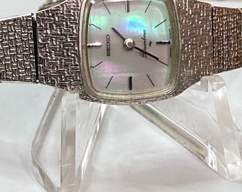Vintage 1975 Seiko Rainbow Mother of Pearl Dial White Gold Plated Bezel Hand Winding Ladies Watch w/ 9-5mm Seiko Stainless Steel Band!