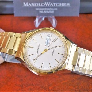 Retro 1990 Caravelle Gold Tone English/Spanish Calendar Men's Watch w/ 17mm Band