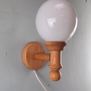 Vintage Herda Wall lamp oak with glass ball marked