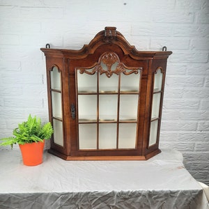 Antique-style walnut display cabinet with beautiful carving