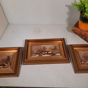 Set of 3 Classic Landscape Paintings in gold-colored ornamental frame.